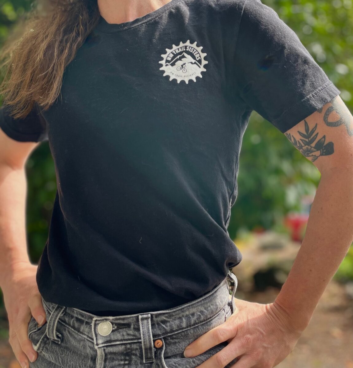 Model wearing Trail Sisters t-shirt that shows the design on the front of the shirt.